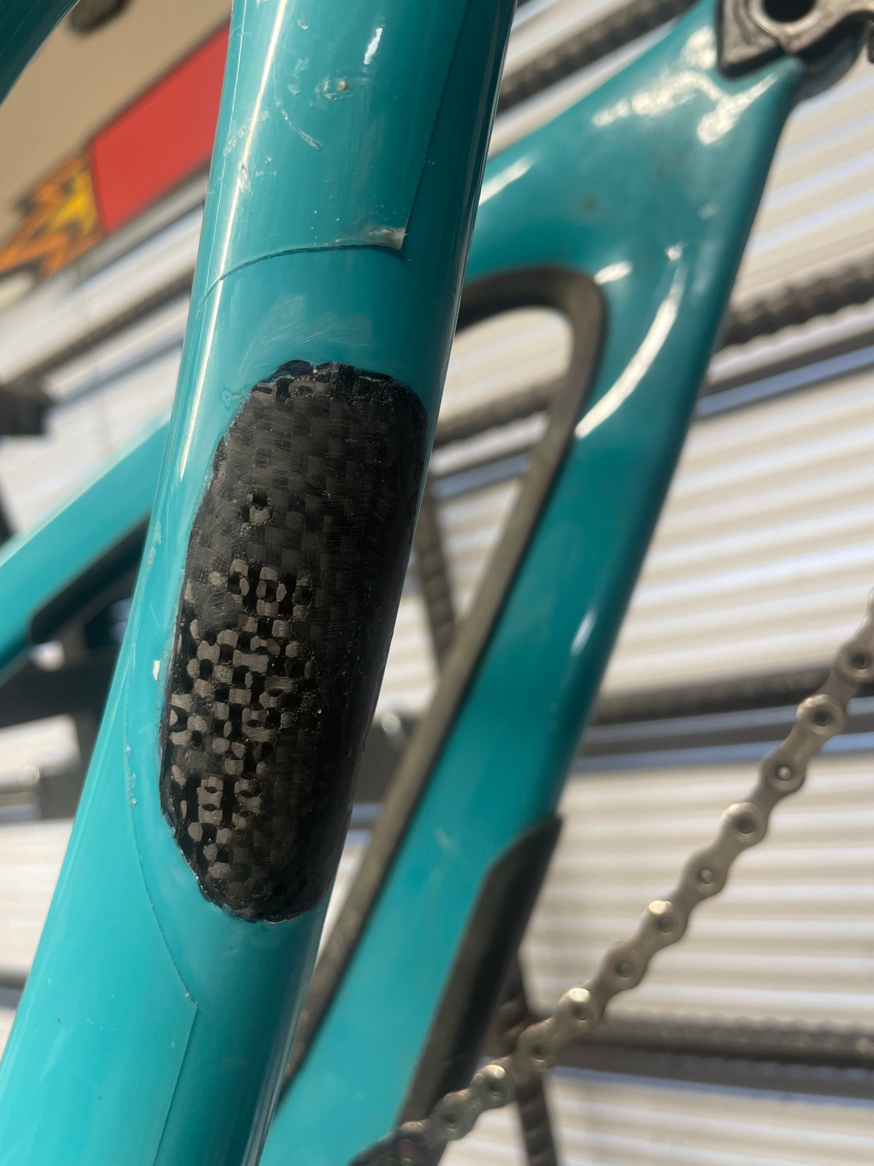 Carbon fiber seat stay repair on a bicycle frame — detail shot of finished repair