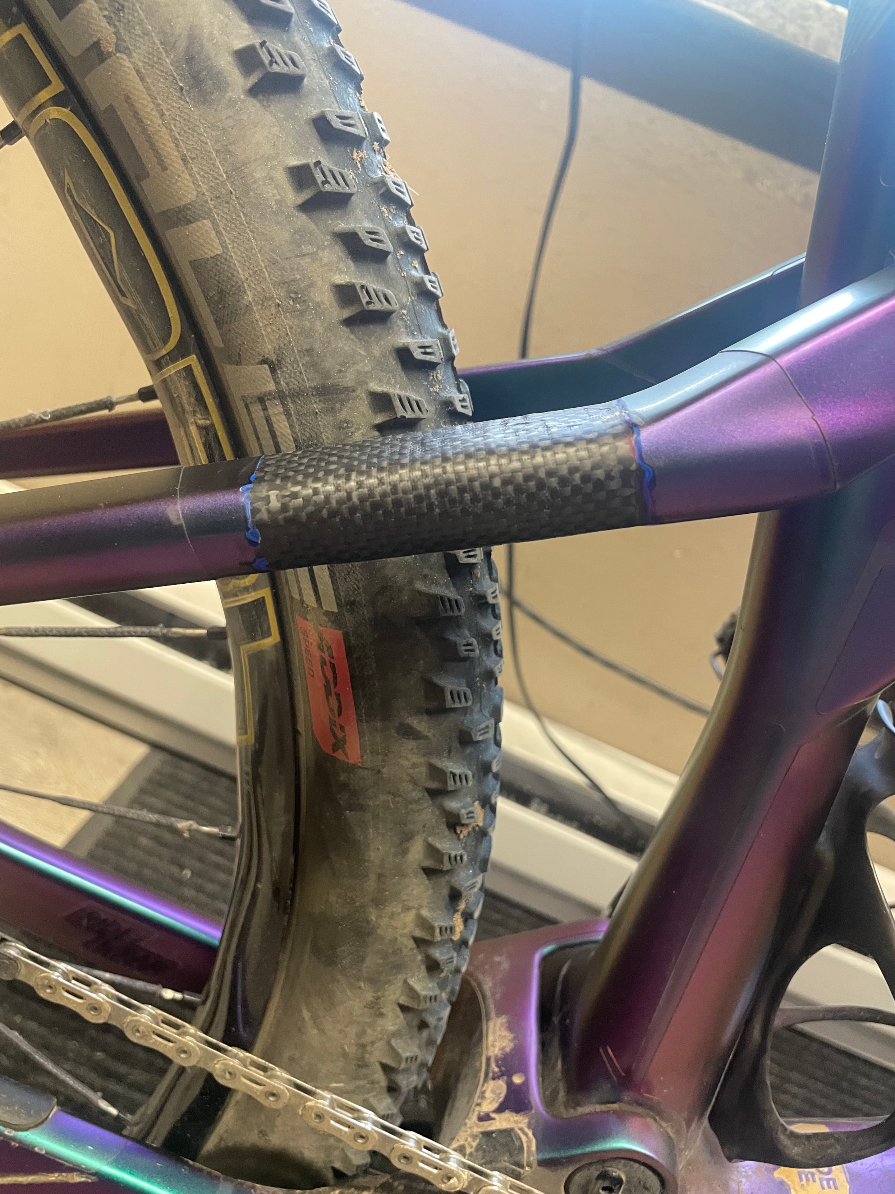 Carbon fiber seat stay repair close-up showing structural patch and finish work