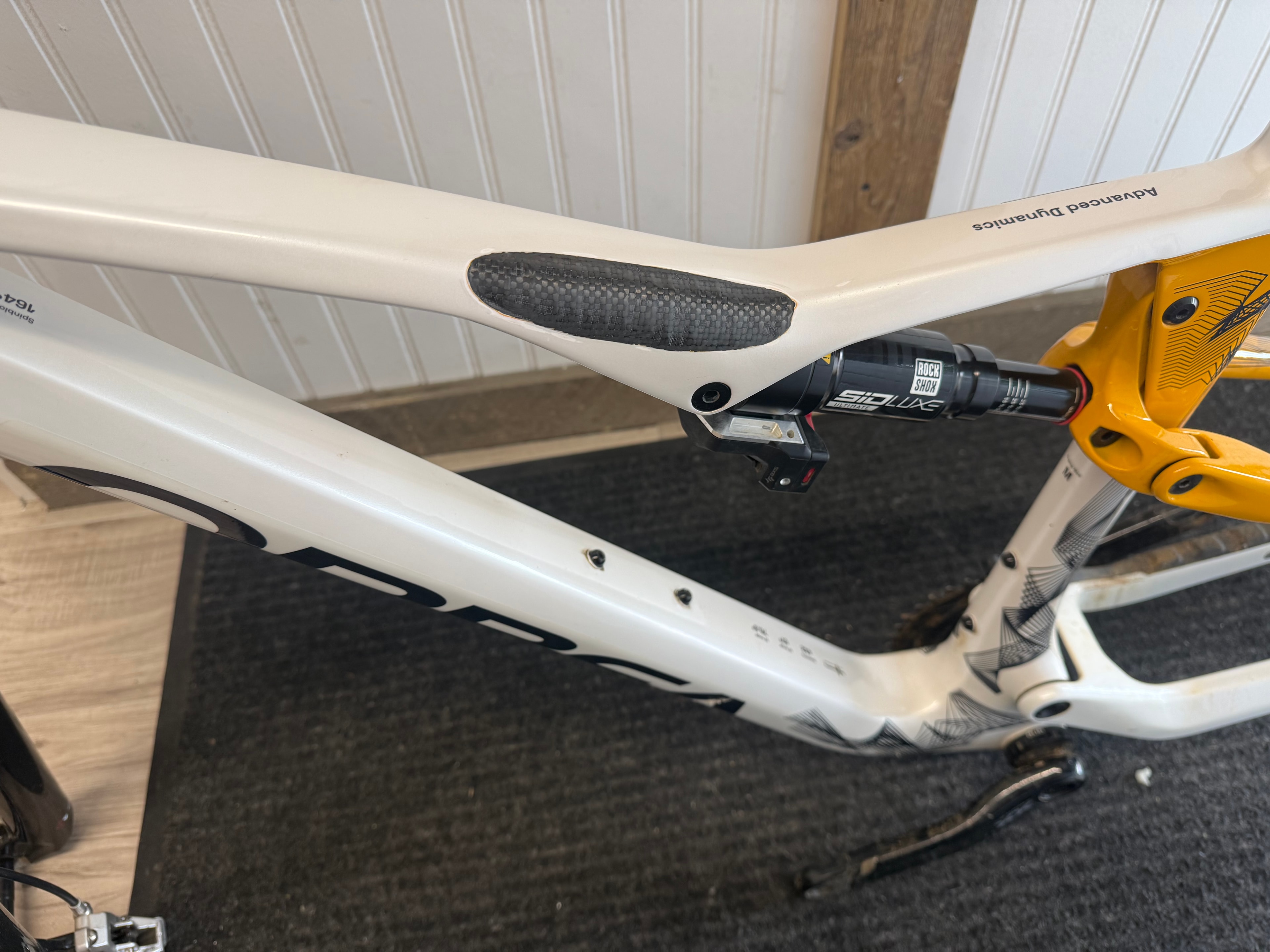 Carbon fiber top tube repair on a white Specialized Stumpjumper